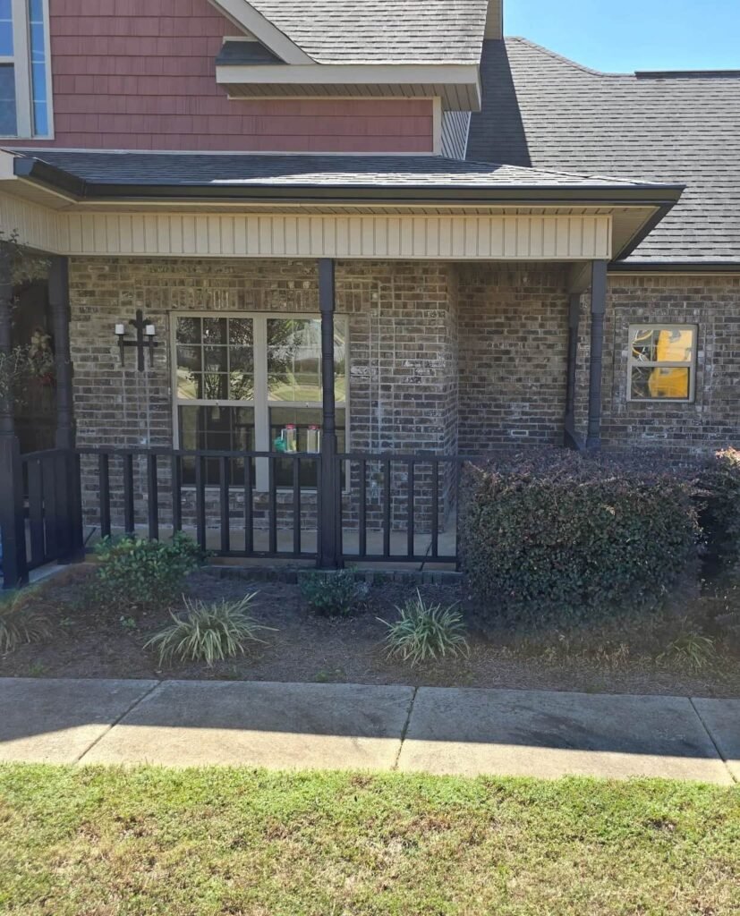 Front porch view of a Middle Georgia home showing the roofline and brick exterior before seamless aluminum gutter installation by BC Gutters.